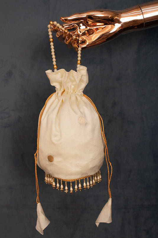 Stunning Jacquard Work Art Silk Potli Bag With Moti Handle In Cream Color