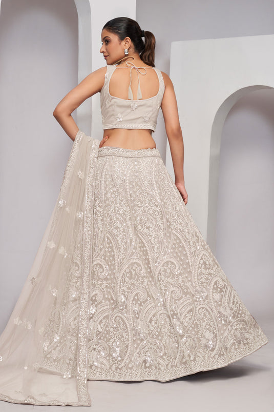 Off White Color Net Fabric Coveted Lehenga With Sequins Work