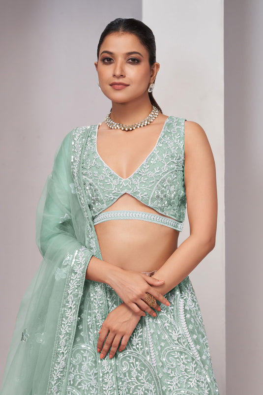 Engaging Sea Green Color Net Fabric Lehenga With Sequins Work