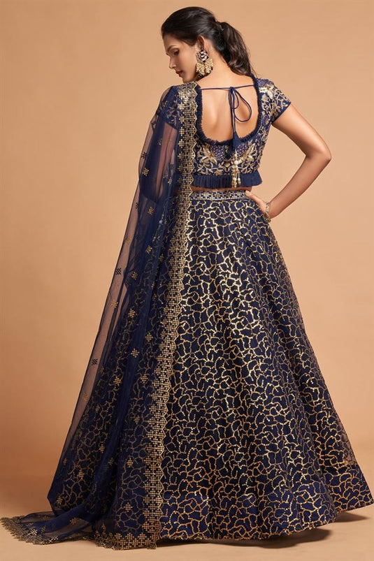 Sangeet Wear Net Fabric Classic Navy Blue Color Lehenga With Embroidered Designs