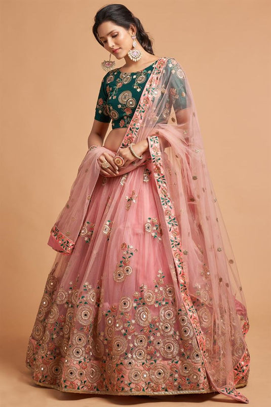 Sangeet Wear Peach Color Net Fabric Mesmeric Lehenga With Embroidered Work