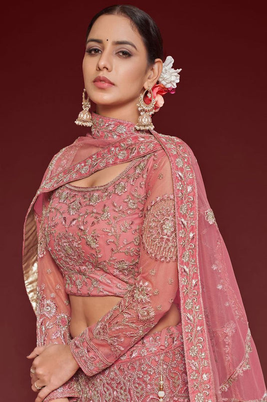 Tempting Net Fabric Peach Color Lehenga With Embroidered Work