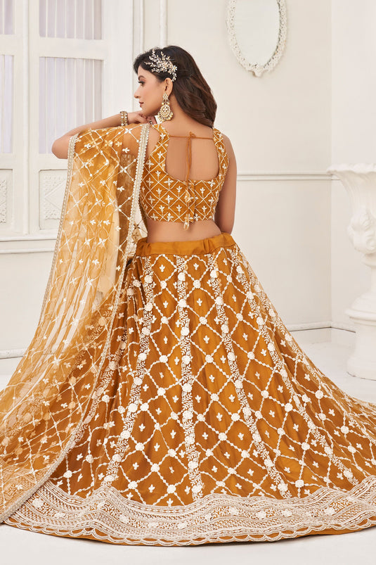Net Wedding Wear Lehenga Choli In Mustard With Embroidery Work