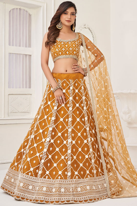 Net Wedding Wear Lehenga Choli In Mustard With Embroidery Work